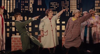 Movie still from “Lady Bird” (2017), directed by Greta Gerwig – A group of people standing in front of a building; Medium shot, Over the shoulder angle