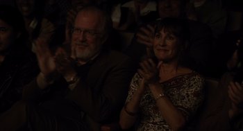 Movie still from “Lady Bird” (2017), directed by Greta Gerwig – A man and a woman clapping in a dark room; Medium shot, High angle