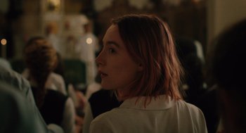 Movie still from “Lady Bird” (2017), directed by Greta Gerwig – A woman with red hair is looking to the side; Close Up shot, Over the shoulder angle