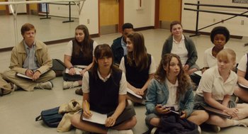 Movie still from “Lady Bird” (2017), directed by Greta Gerwig – A group of young people sitting on the floor; Wide shot, High angle