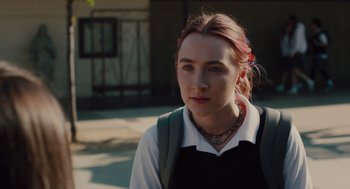 Movie still from “Lady Bird” (2017), directed by Greta Gerwig – A woman with a red hair and a white shirt; Close Up shot, Over the shoulder angle