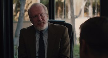 Movie still from “Lady Bird” (2017), directed by Greta Gerwig – An older man sitting in a chair in front of a window; Close Up shot, Over the shoulder angle
