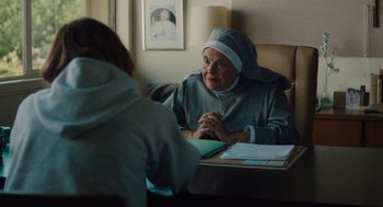 Movie still from “Lady Bird” (2017), directed by Greta Gerwig – An older woman sitting at a table talking to a younger woman; Medium shot, Over the shoulder angle