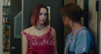 Movie still from “Lady Bird” (2017), directed by Greta Gerwig – A woman in a red dress is looking at another woman in a blue shirt; Medium shot, Over the shoulder angle