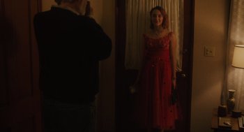 Movie still from “Lady Bird” (2017), directed by Greta Gerwig – A man taking a picture of a woman in a red dress; Medium shot, Over the shoulder angle