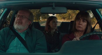 Movie still from “Lady Bird” (2017), directed by Greta Gerwig – A group of people in the back seat of a car; Medium shot, Over the shoulder angle