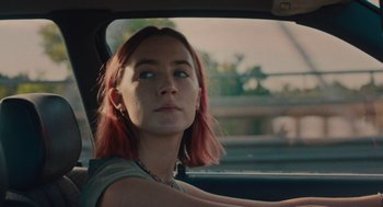 Movie still from “Lady Bird” (2017), directed by Greta Gerwig – A woman sitting in the driver's seat of a car; Close Up shot, Over the shoulder angle