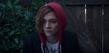 Movie still from “Marianne” (2019), created by Samuel Bodin – A person wearing a jacket and a red hat; Close Up shot, High angle
