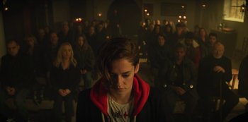 Movie still from “Marianne” (2019), created by Samuel Bodin – A woman in a crowd of people in front of a crowd; Medium shot, High angle