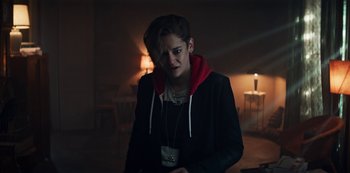 Movie still from “Marianne” (2019), created by Samuel Bodin – A woman in a black jacket is holding a cup; Medium shot, Over the shoulder angle