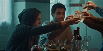 Movie still from “Marianne” (2019), created by Samuel Bodin – A man and a woman sitting at a dinner table; Medium shot, Low angle