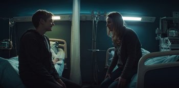 Movie still from “Marianne” (2019), created by Samuel Bodin – Two people in a hospital room talking to each other; Medium shot, Over the shoulder angle