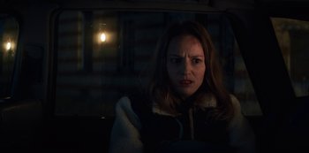 Movie still from “Marianne” (2019), created by Samuel Bodin – A woman in a car looking at the camera; Close Up shot, Over the shoulder angle