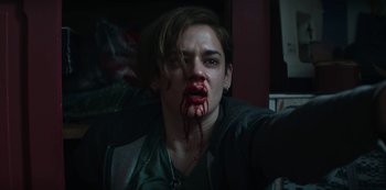 Movie still from “Marianne” (2019), created by Samuel Bodin – A person with blood on their face and mouth; Close Up shot, Low angle
