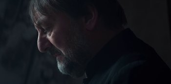 Movie still from “Marianne” (2019), created by Samuel Bodin – A person with a beard; Close Up shot, Over the shoulder angle