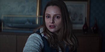 Movie still from “Marianne” (2019), created by Samuel Bodin – A young woman stares into the camera; Close Up shot, Over the shoulder angle