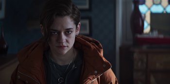 Movie still from “Marianne” (2019), created by Samuel Bodin – A person with a necklace and a jacket; Close Up shot, Over the shoulder angle