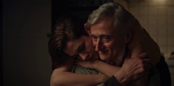 Movie still from “Marianne” (2019), created by Samuel Bodin – An older man and a younger woman hugging; Close Up shot, Over the shoulder angle