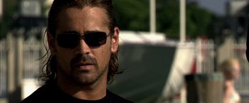 Movie still from “Miami Vice” (2006), directed by Michael Mann – A person wearing sunglasses; Close Up shot, Over the shoulder angle