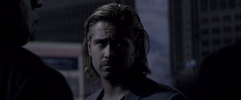 Movie still from “Miami Vice” (2006), directed by Michael Mann – A man with long blonde hair wearing a black suit; Close Up shot, Over the shoulder angle