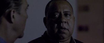 Movie still from “Miami Vice” (2006), directed by Michael Mann – A person wearing a black shirt; Close Up shot, Low angle