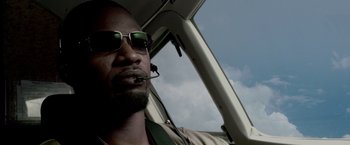 Movie still from “Miami Vice” (2006), directed by Michael Mann – A person in a helicopter; Close Up shot, Low angle