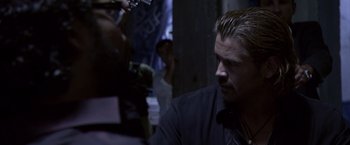 Movie still from “Miami Vice” (2006), directed by Michael Mann – A person wearing a black shirt; Close Up shot, Over the shoulder angle