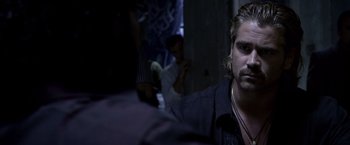 Movie still from “Miami Vice” (2006), directed by Michael Mann – A person in a room with other people; Close Up shot, Over the shoulder angle