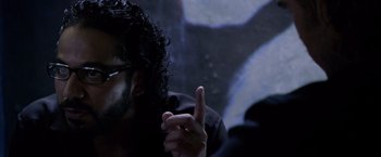 Movie still from “Miami Vice” (2006), directed by Michael Mann – A person holding a finger up; Close Up shot, Over the shoulder angle