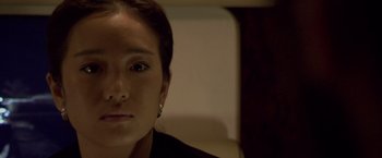 Movie still from “Miami Vice” (2006), directed by Michael Mann – A person wearing a black shirt; Close Up shot, High angle