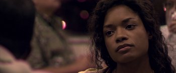 Movie still from “Miami Vice” (2006), directed by Michael Mann – A person with curly black hair; Close Up shot, Over the shoulder angle