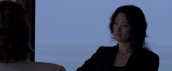 Movie still from “Miami Vice” (2006), directed by Michael Mann – A woman sitting in front of the ocean at night; Close Up shot, Over the shoulder angle