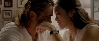 Movie still from “Miami Vice” (2006), directed by Michael Mann – A man and a woman looking at each other's face; Close Up shot, Low angle