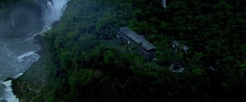 Movie still from “Miami Vice” (2006), directed by Michael Mann – An aerial view of a house surrounded by trees; Extreme Wide shot, Overhead angle