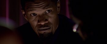 Movie still from “Miami Vice” (2006), directed by Michael Mann – A person looking at the camera; Close Up shot, Over the shoulder angle