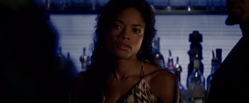 Movie still from “Miami Vice” (2006), directed by Michael Mann – A woman in a leopard print dress in front of a bar; Close Up shot, Over the shoulder angle