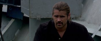 Movie still from “Miami Vice” (2006), directed by Michael Mann – A person with long hair and a beard; Close Up shot, Over the shoulder angle