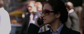 Movie still from “Miami Vice” (2006), directed by Michael Mann – A woman wearing sunglasses talking on a cell phone; Close Up shot, Low angle