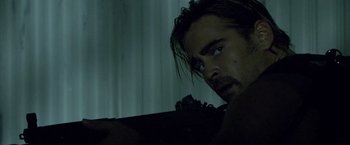 Movie still from “Miami Vice” (2006), directed by Michael Mann – A person holding a gun; Close Up shot, Low angle