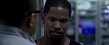 Movie still from “Miami Vice” (2006), directed by Michael Mann – A person with a beard; Close Up shot, Over the shoulder angle