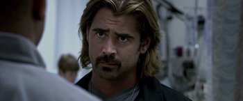 Movie still from “Miami Vice” (2006), directed by Michael Mann – A person with long hair and a beard; Close Up shot, Over the shoulder angle