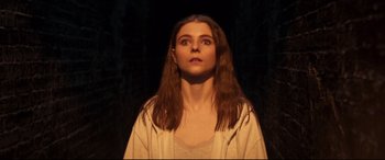 Movie still from “Last Night in Soho” (2021), directed by Edgar Wright – A woman with long brown hair is looking at the camera; Close Up shot, Low angle