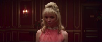 Movie still from “Last Night in Soho” (2021), directed by Edgar Wright – A woman in a pink dress with a long blonde hair style; Close Up shot, Low angle