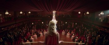 Movie still from “Last Night in Soho” (2021), directed by Edgar Wright – A woman standing in front of an audience in a theater; Wide shot, High angle