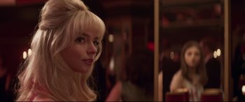 Movie still from “Last Night in Soho” (2021), directed by Edgar Wright – A woman with blonde hair and a long ponytail; Close Up shot, Over the shoulder angle