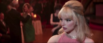Movie still from “Last Night in Soho” (2021), directed by Edgar Wright – A woman in a pink dress is in a ballroom; Close Up shot, Over the shoulder angle
