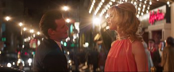 Movie still from “Last Night in Soho” (2021), directed by Edgar Wright – A man and a woman talking in the street; Medium shot, Low angle