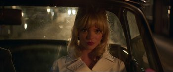 Movie still from “Last Night in Soho” (2021), directed by Edgar Wright – A woman with blonde hair wearing a white shirt; Close Up shot, Low angle