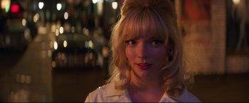 Movie still from “Last Night in Soho” (2021), directed by Edgar Wright – A woman with blonde hair wearing a white dress shirt; Close Up shot, Over the shoulder angle