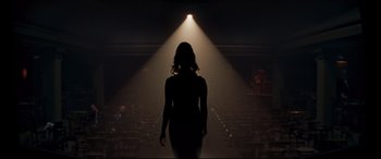 Movie still from “Last Night in Soho” (2021), directed by Edgar Wright – A woman standing in the middle of an auditorium; Wide shot, Low angle